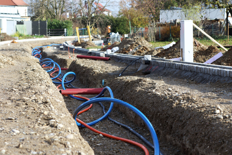 Laying a fiber optic cable for fast internet, Electricity and telephone cable along a new street.