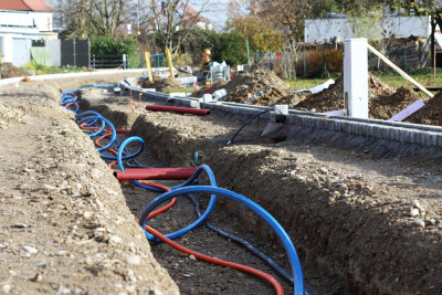 Laying a fiber optic cable for fast internet, Electricity and telephone cable along a new street.