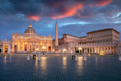 Saint Peter's Basilica and St. Peter's Square, Vatican City, Rome, Italy at sunrise.