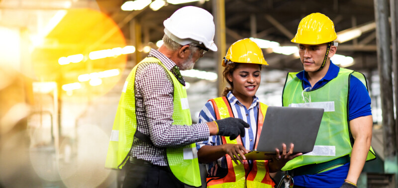 Professional Mechanical Engineer team Working on Personal Computer at Metal lathe industrial manufacturing factory.