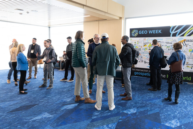 Attendees talking at Geo Week 2025
