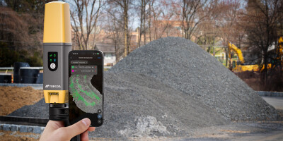 Hand holding new CR-H1 solution on a construction site.