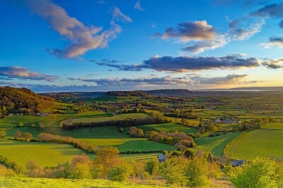 Twilight with views across the Severn valley towards the Severn estuary from Coaley Peak nature reserve near Uley, The Cotswolds, Gloucestershire, UK
