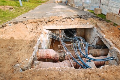 Pipes and communication cables in trench, underground utility systems.