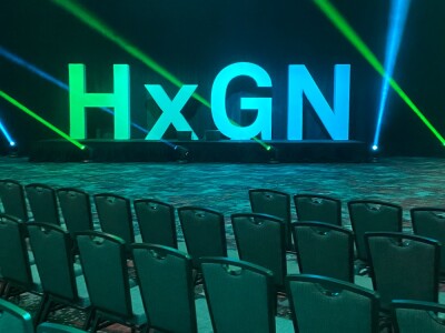 Big "HxGN" sign placed in the keynote ballroom at HxGN LIVE Global 2023.
