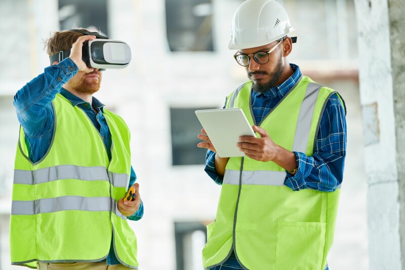 Construction workers on-site utilizing VR technology.