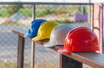 Construction hard hat safety tools equipment workers in construction site engineering protection head hang on wood wall. 