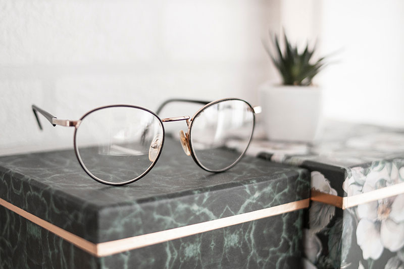 A pair of reading glasses resting on a table