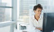 Woman giving a presentation to her table of coworkers