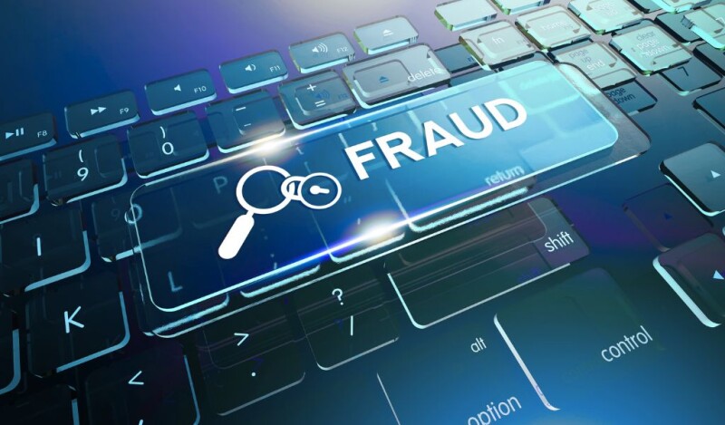 keyboard with the word fraud written largely above it