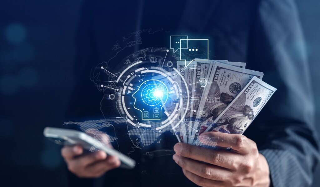 A businessman holding cash in his left hand and a smartphone in his right hand, with an AI hologram in between.