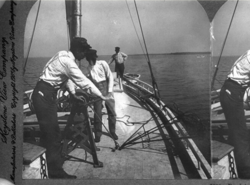 Black Fishermen harvesting oysters in 1905 on the Chesapeake Bay in Maryland on a sailboat.