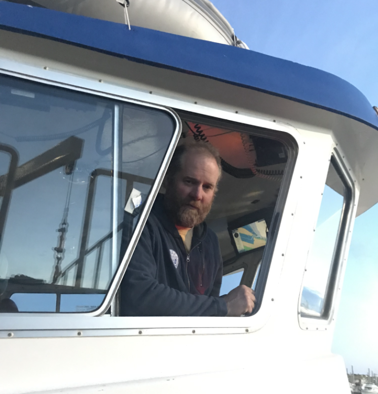 2023 National Fisherman Highliner, Matt Alward in the window of his fishing vessel.