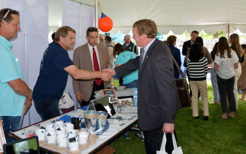 Senator Ed McBroom shakes hands with commercial fishermen Cam McMurry from Big Stone Bay Fisheries and Dana Serafin from Serafin Fisheries.