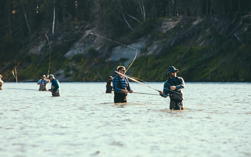 A group fly fishing in a river.