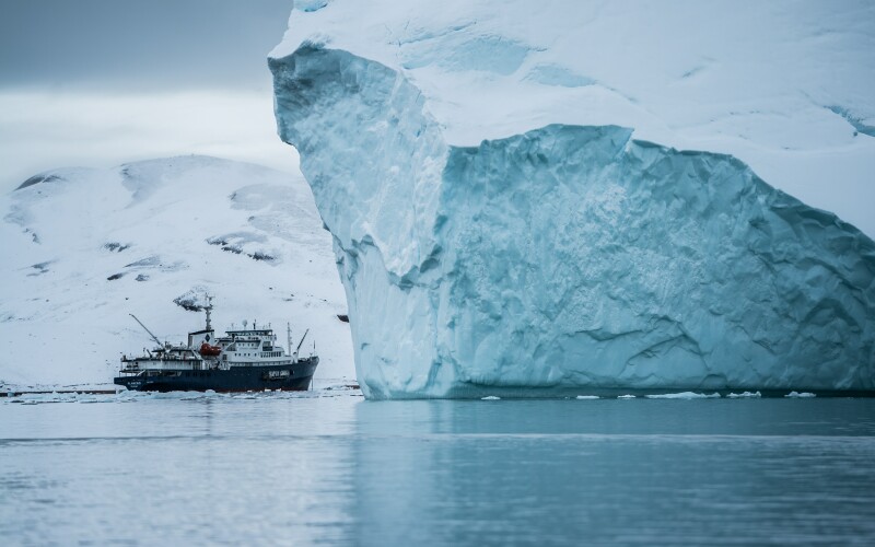 Processing boat navigating in cold seas with an iceberg
