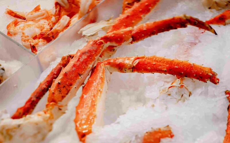 King crab legs on ice. Photo by Jason Leung on Unsplash
