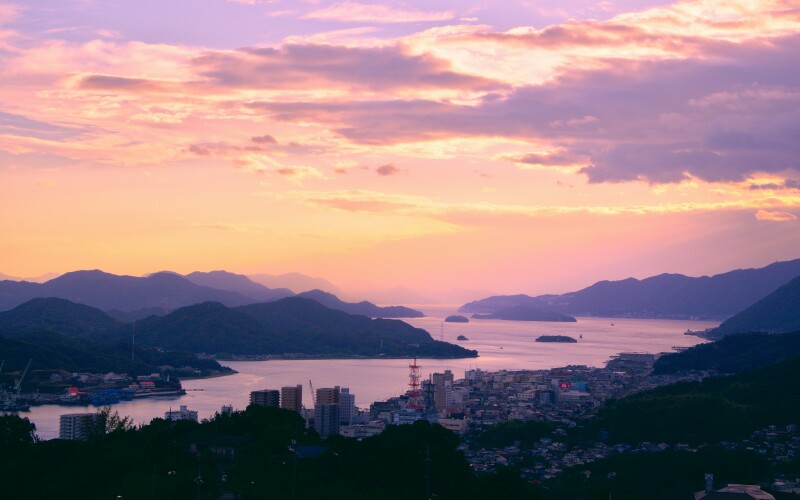 Coast of Japan at sunset over the mountains