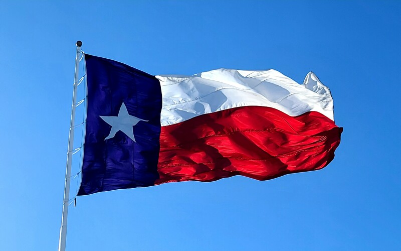 Texas flag flying in the wind