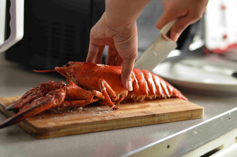 Cooked lobster on cutting board with knife