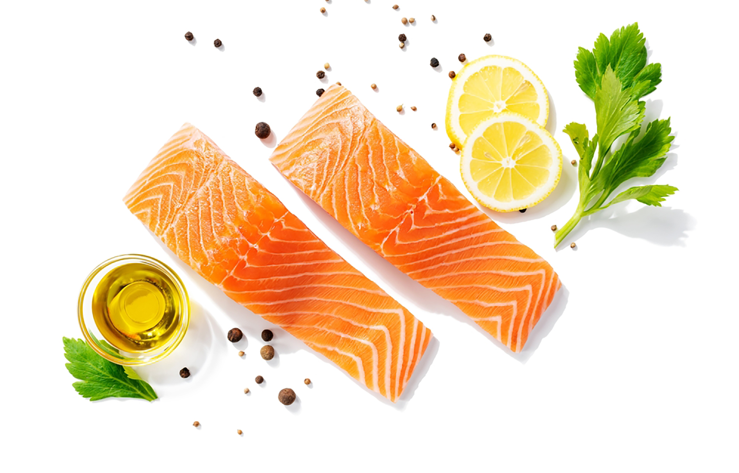 Salmon fillets surrounded by lemon wedges and granishes