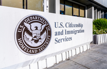 A photo of a U.S. Citizenship and Immigration Services building.