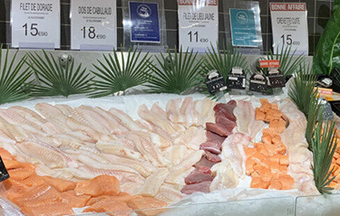 A display of salmon, cod, and other fillets at a Norwegian seafood market.