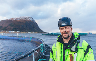 A worker at a salmon net pen at a salmon farm in Norway.
