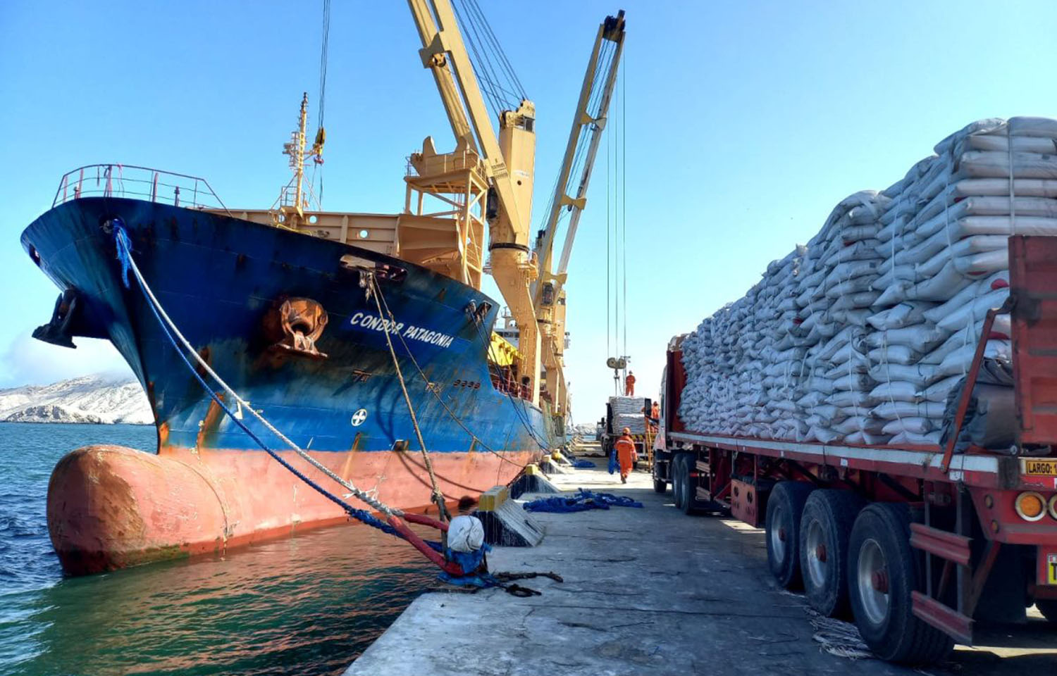An Austral Group cargo vessel unloading bags of fishmeal onto trucks