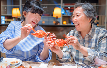 Restaurant-goers eating crab.