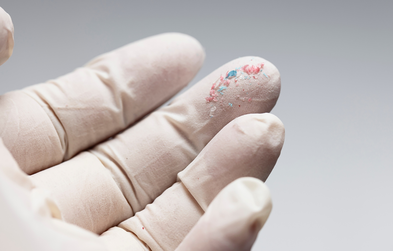 Microplastics on a gloved hand