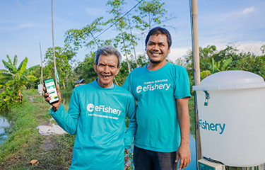 eFishery Co-Founder and CEO Gibran Huzaifah with a shrimp farmer.
