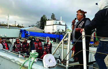 A representative of the Gwa’sala-’Nakwaxda’xw Nation of Port Hardy addresses a crowd at a finfish aquaculture operation.