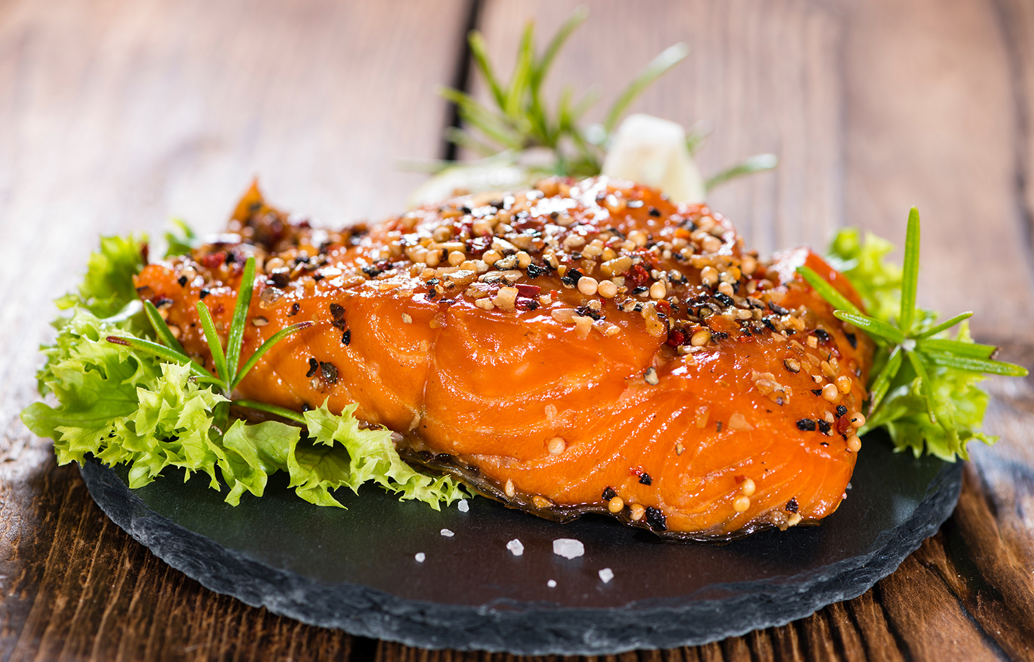 A salmon fillet on a bed of garnish