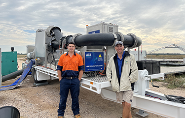 Lachlan Basett, General Manager of Fresh by Design, and Mat Ryan, Managing Director of Aquna Sustainable Murray Cod, standing in front of their in-water stunning solution.