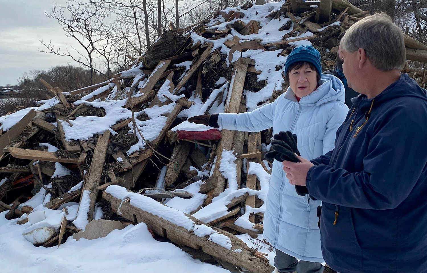 A photo of U.S. Senator Susan Collins (R-Maine) assessing storm damage.