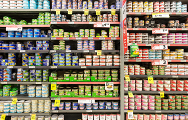 Canned tuna on grocery store shelves.