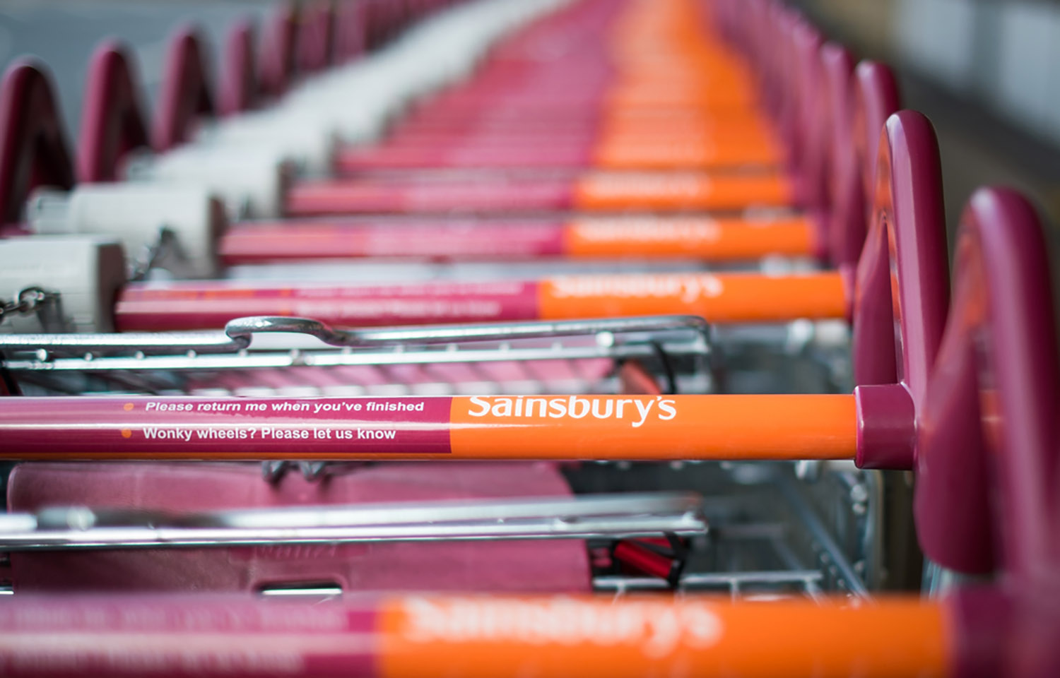A row of Sainsbury's shopping carts