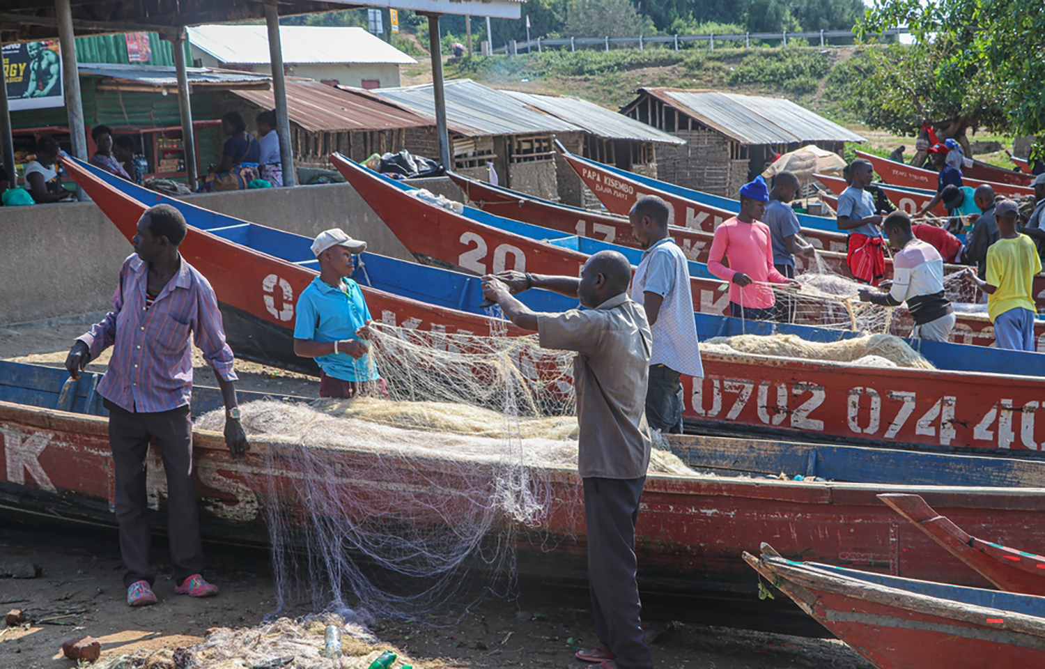 Uganda fishermen untangling a net