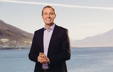 Norwegian Seafood Council Managing Director Christian Chramer standing on the shoreline.