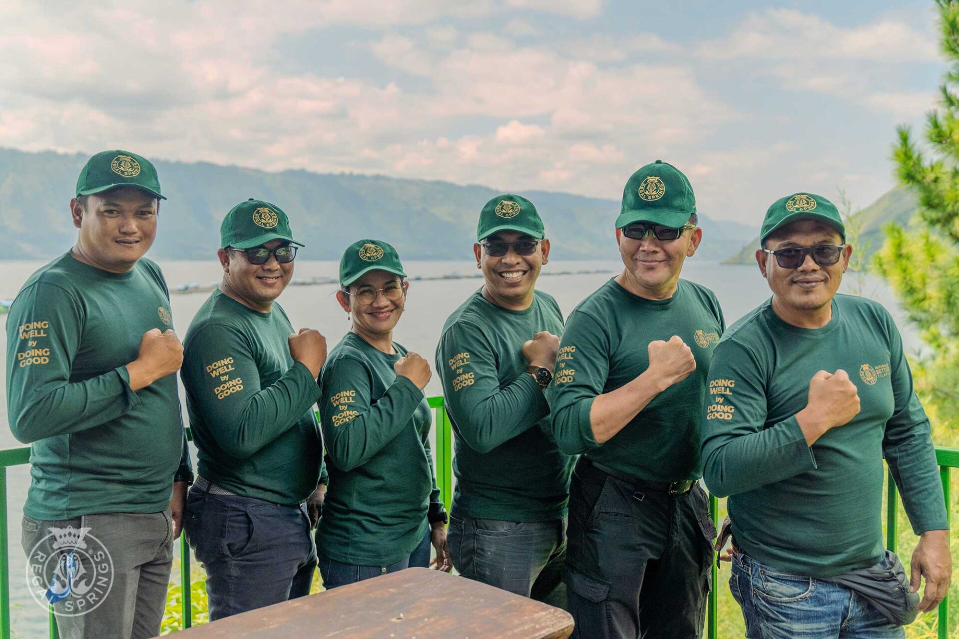 Regal Springs workers wearing branded gear with the company's motto, "doing well by doing good."