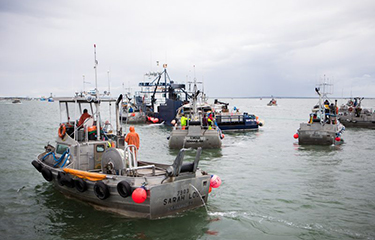 Gillnetters line up to deliver to the tender in Alaska’s Bristol Bay salmon fishery.