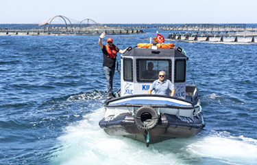 A boat touring a fish farm in the Mediterranean