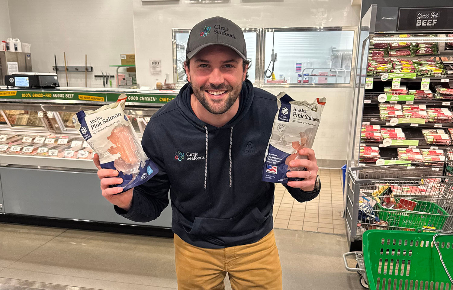 Circle Seafoods Co-Founder Eren Shultz holding two bags of pink salmon