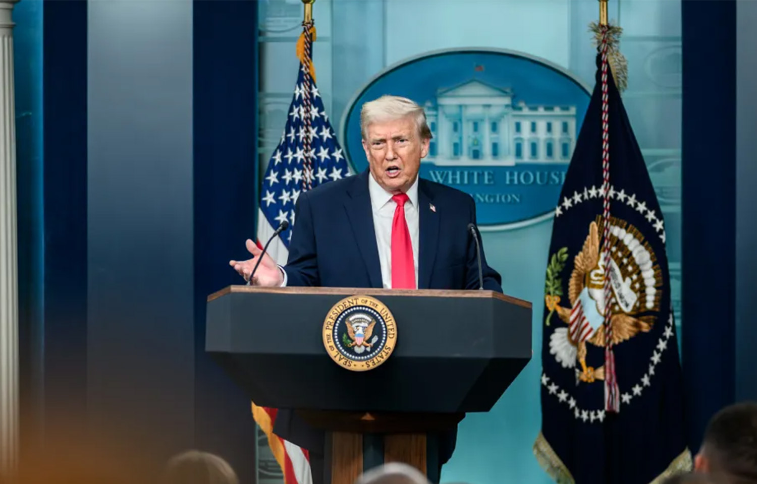 Donald Trump at a podium in the White House press room