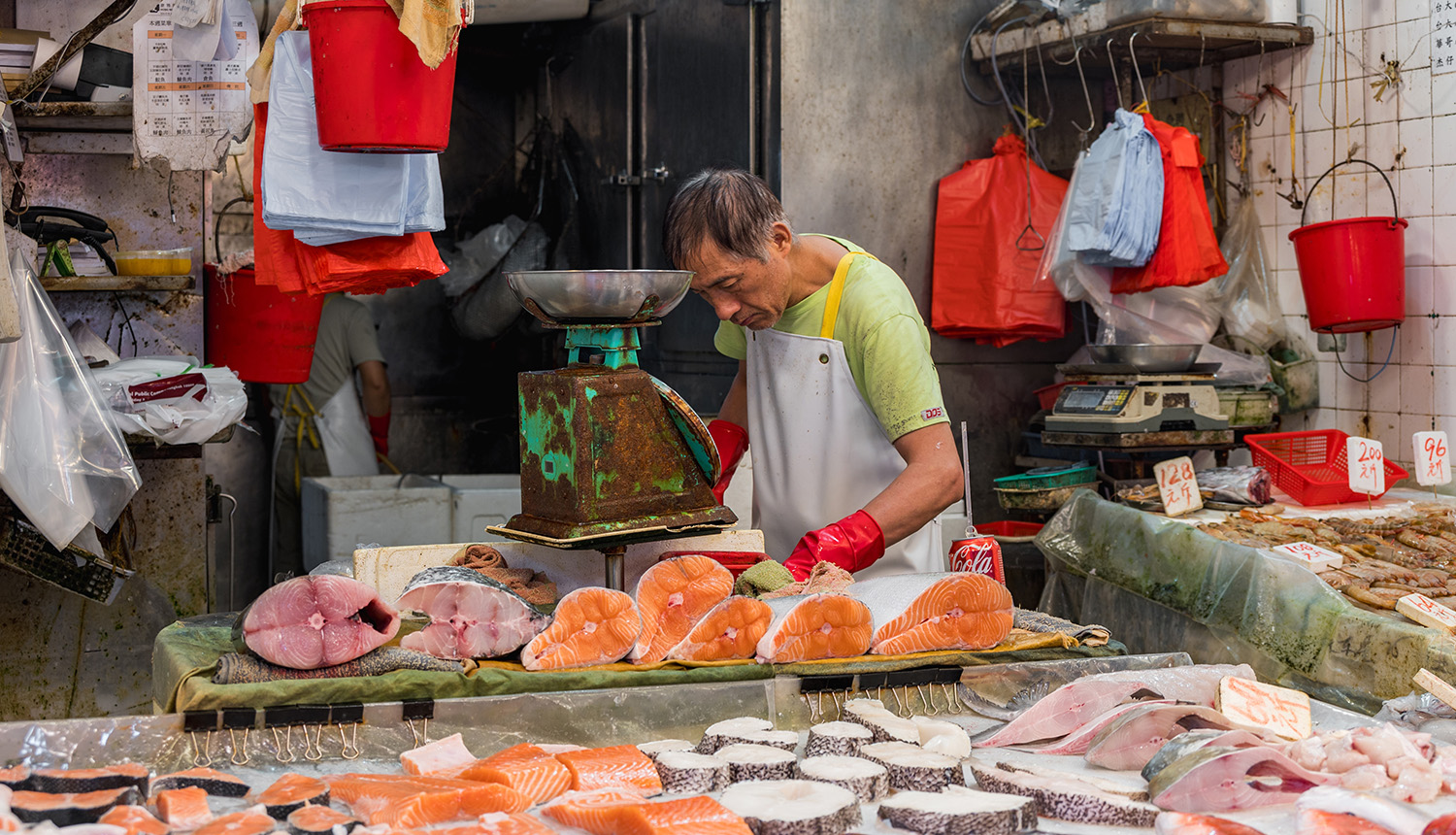 market worker cutting fish