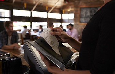 A bill being prepared at a restaurant.