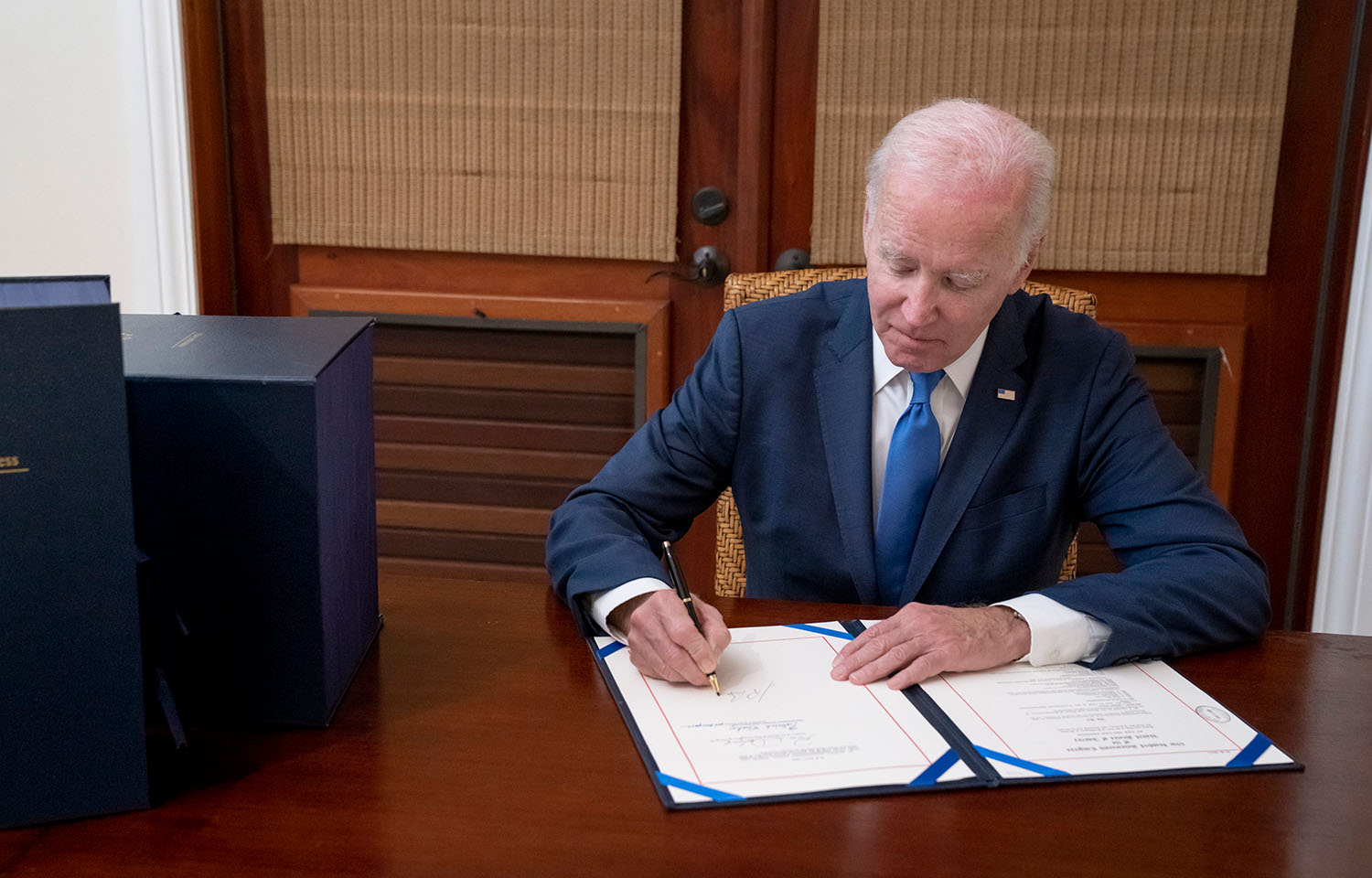 U.S. President Joe Biden signing a document