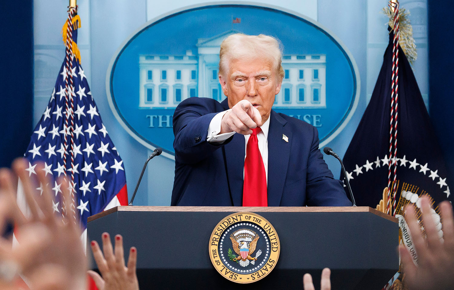 U.S. President Donald Trump pointing at a reporter during a press conference