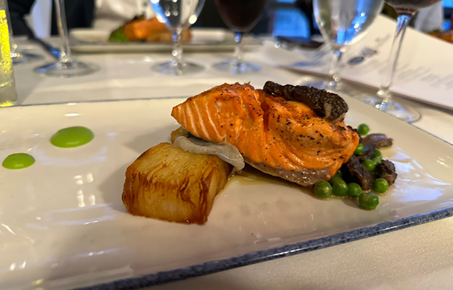 A Copper River salmon fillet on a plate topped with caviar offered by Legal Sea Foods